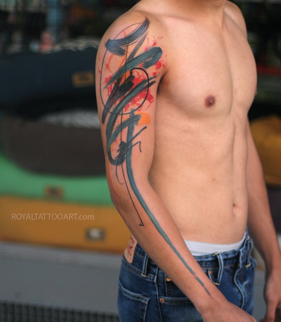 Abstract black brushstroke watercolor tattoo on male chest and arm, bold calligraphy-inspired ink design by Royal Jafarov at Royal Tattoo Art