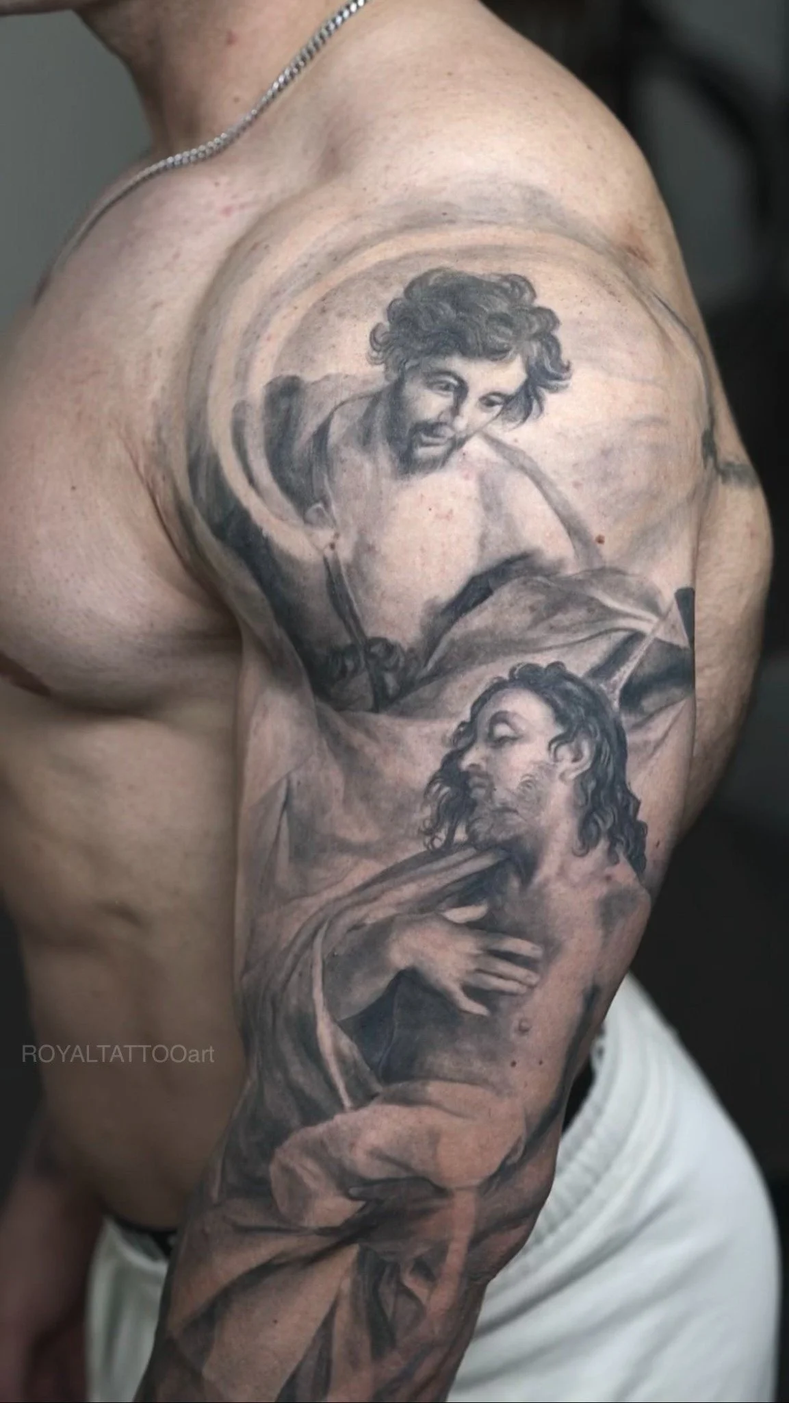 Black and grey religious realism sleeve tattoo with layered spiritual imagery, detailed shading, and a custom full-arm composition.
