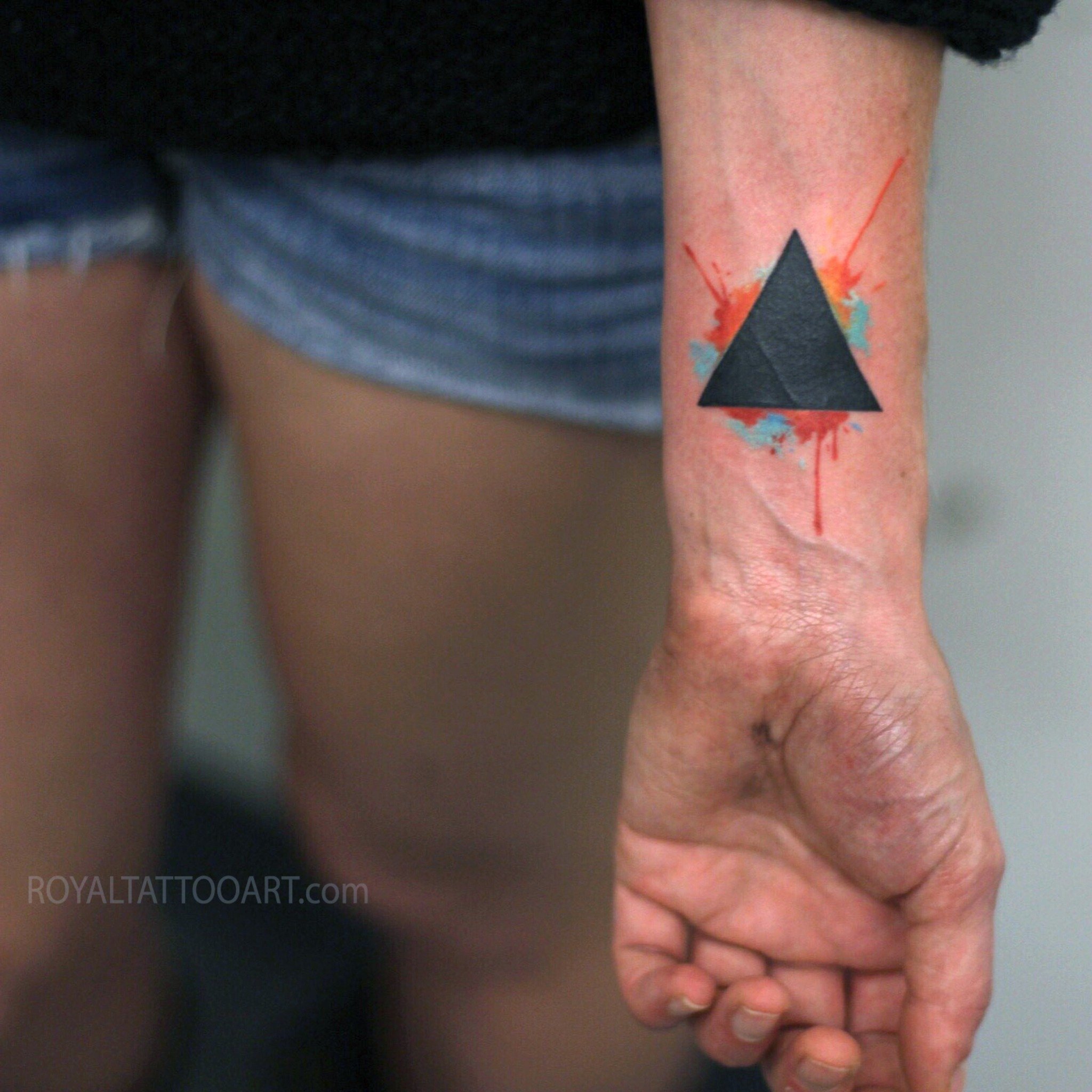 Minimalist geometric black triangle tattoo with red drip accent on wrist, modern graphic ink design by Royal Jafarov at Royal Tattoo Art