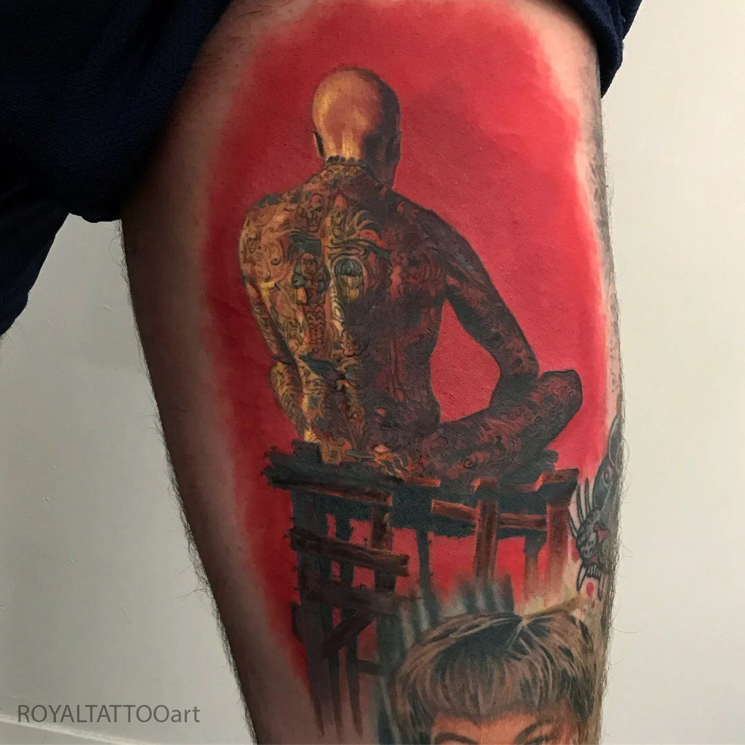 Striking color realism back figure tattoo covering the back, done in NYC. Royal Tattoo Art's large-scale fine art tattoo work showcases dramatic composition and rich color, transforming the back into a bold canvas for figurative and painterly body ar
