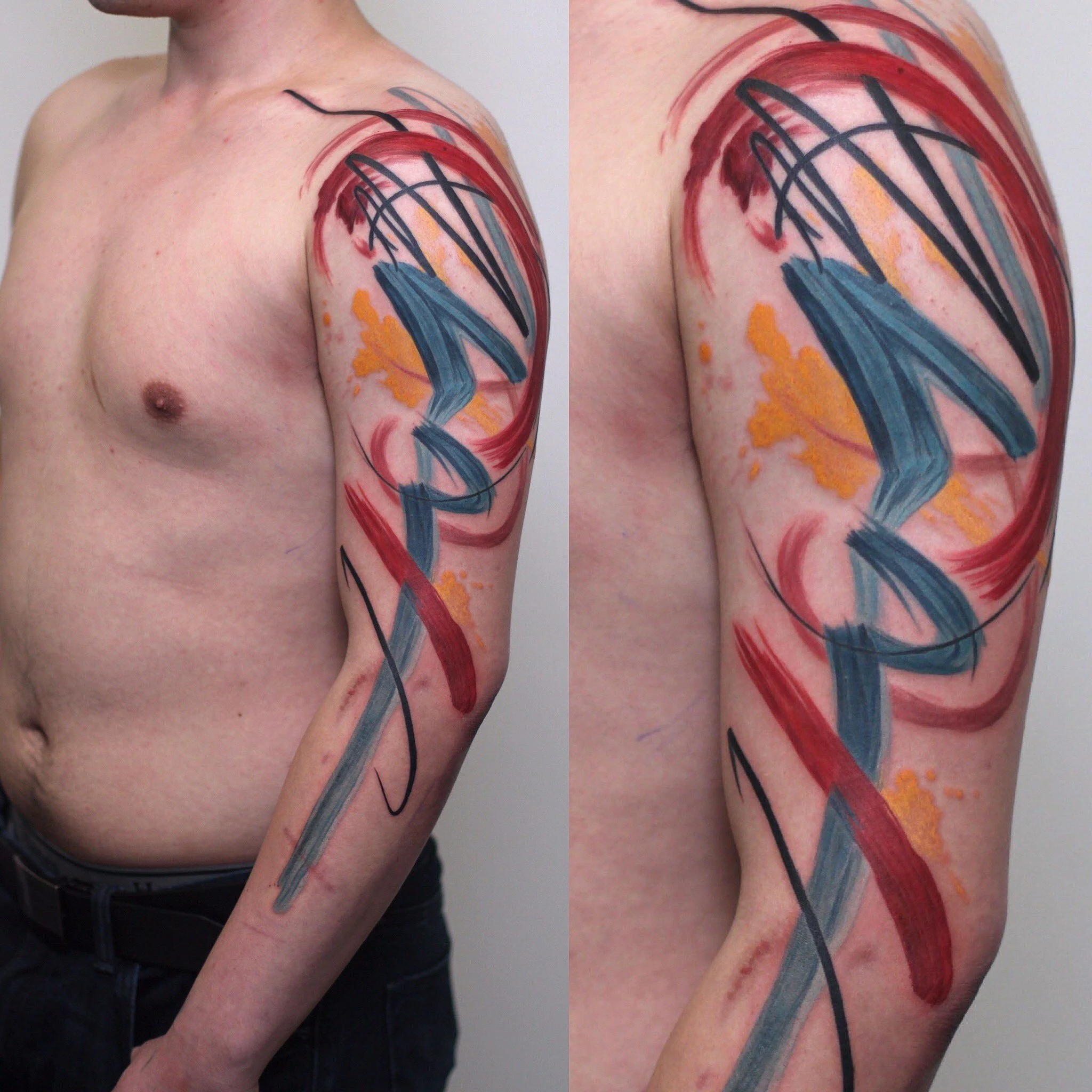 Abstract watercolor tattoo with red and blue brushstrokes on male upper arm and shoulder, expressive ink art by Royal Jafarov at Royal Tattoo Art
