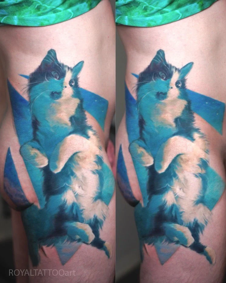 Creative abstract cat pet portrait tattoo featuring a vibrant blue watercolor style, tattooed in NYC. Royal Tattoo Art's unique approach to abstract pet portraits blends artistic expression with heartfelt tribute to your feline companion.