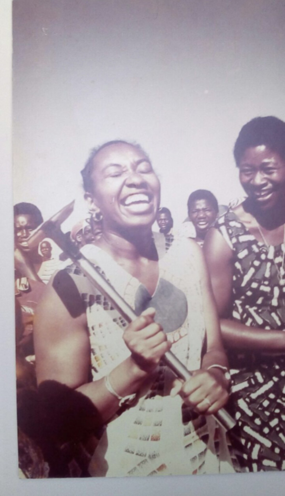 Original family photograph of a Zimbabwean mother laughing, used as the reference for a portrait tattoo.