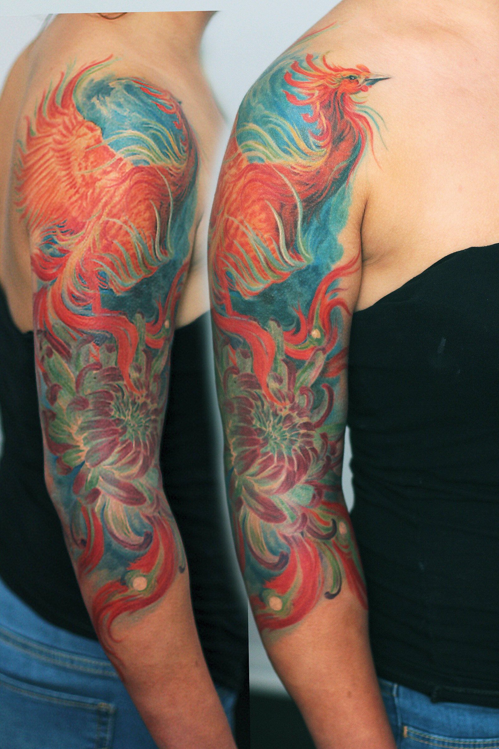 Complementary color tattoos on both arms display swirling floral and abstract shapes in red and green hues, creating a dynamic mirrored effect.