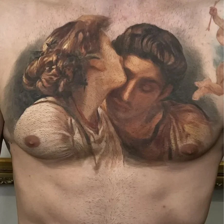 Fine-art realism chest tattoo of a Renaissance-style couple embracing, spanning both sides of the chest.