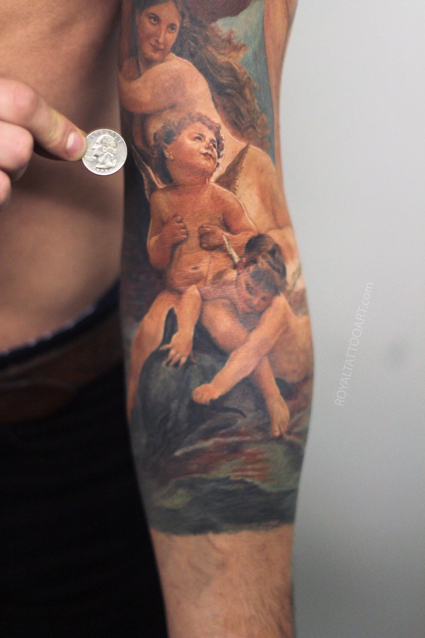 Exquisite Renaissance cherub fine art tattoo on the forearm, created in NYC. Royal Tattoo Art faithfully reproduces the soft, angelic beauty of classical Renaissance cherubs with flawless color realism, ideal for lovers of Old Masters painting and fi