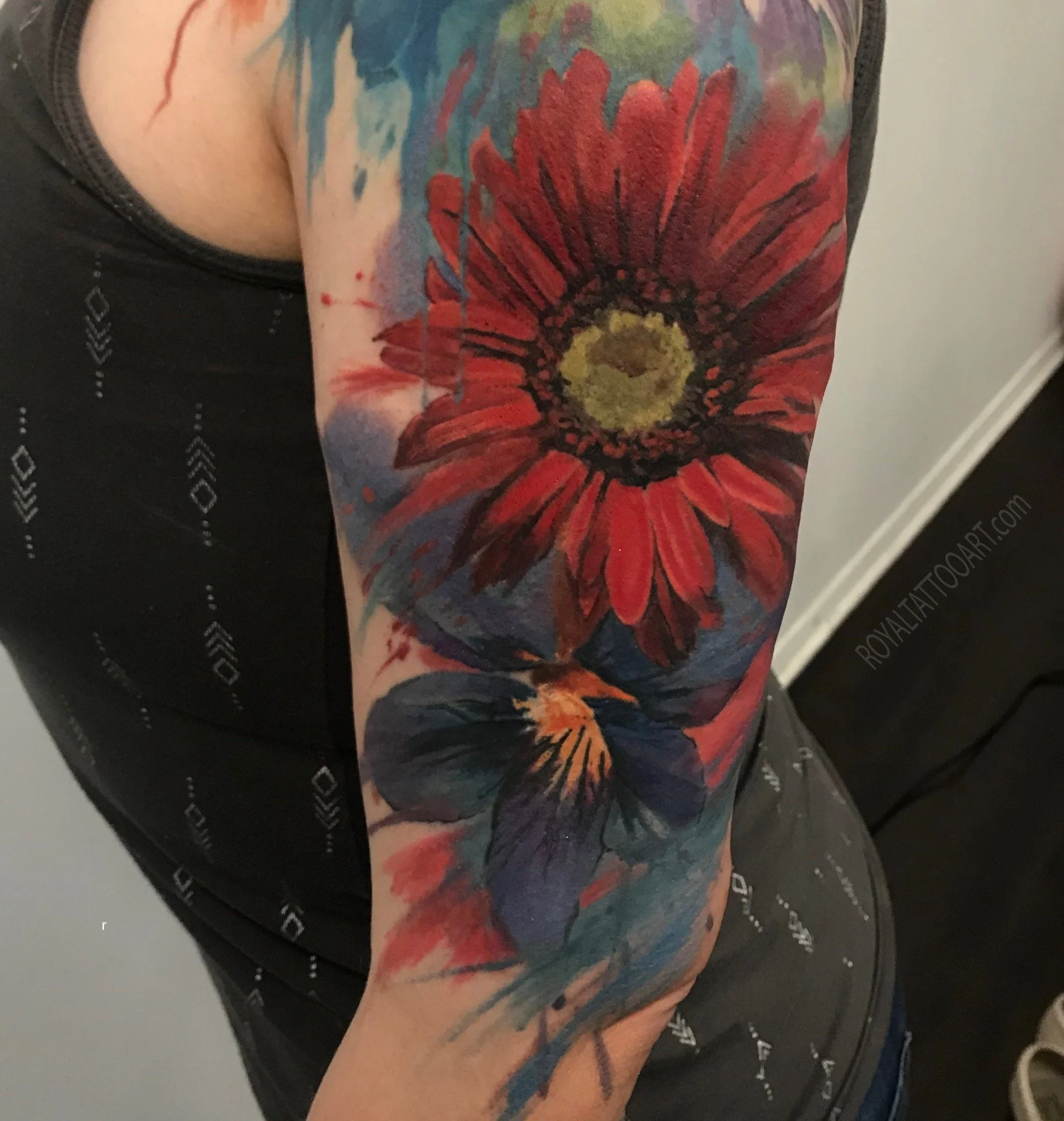 Bold watercolor red sunflower and blue floral tattoo sleeve, vibrant botanical ink artwork by Royal Jafarov at Royal Tattoo Art