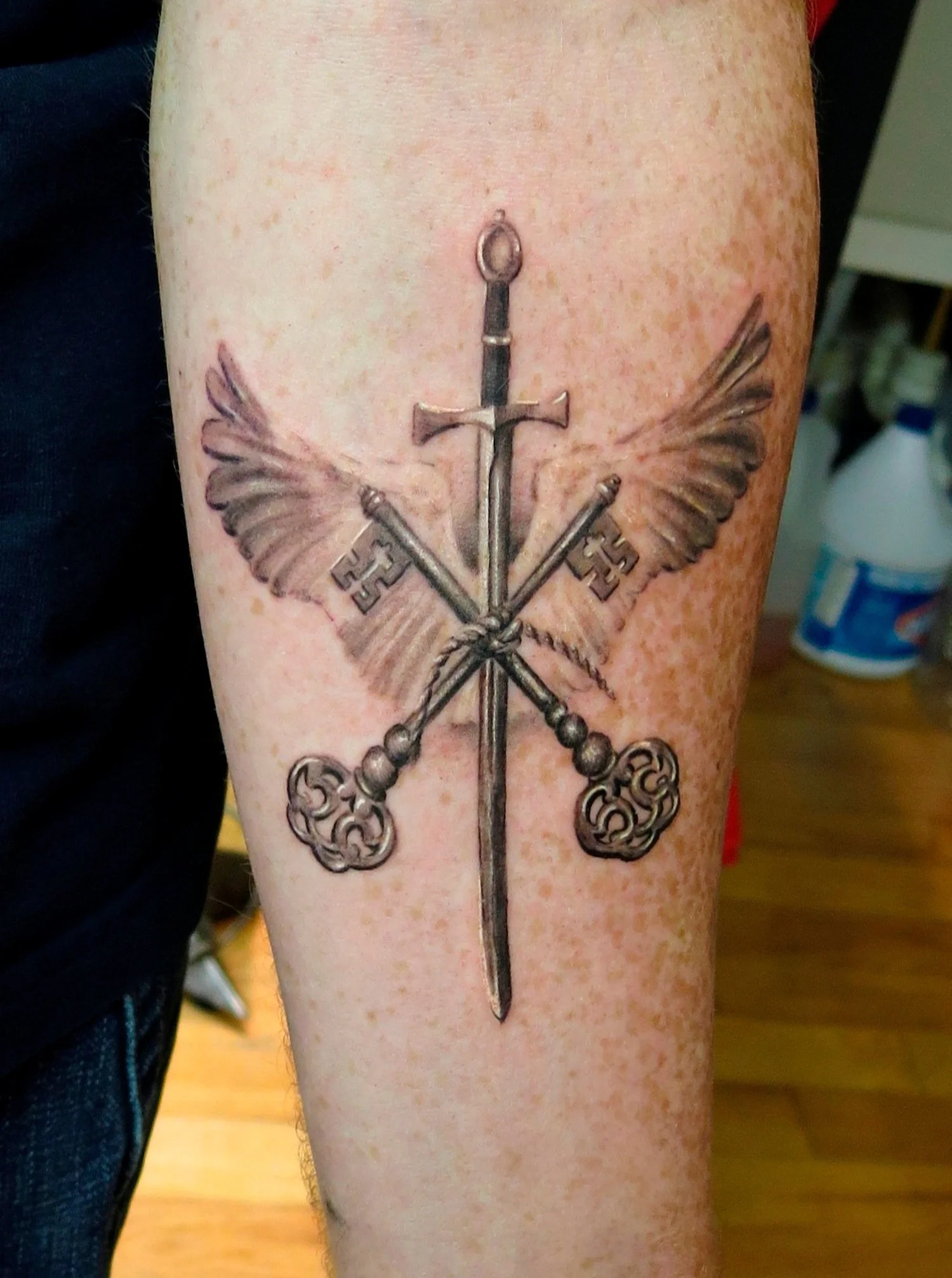 sword-keys-wings-realism-forearm-tattoo-nyc.jpg