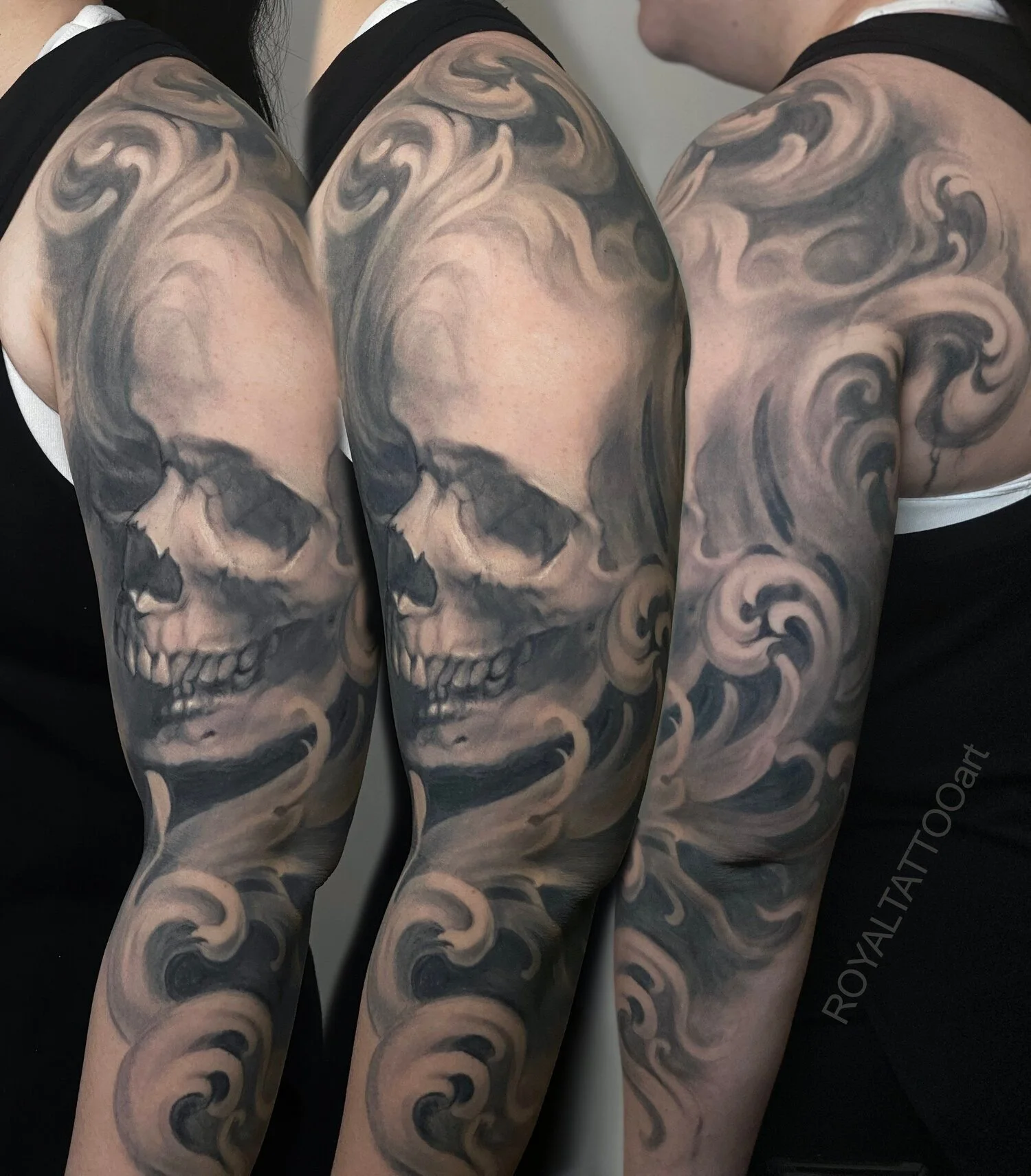 Black and grey skull sleeve tattoo with smoke effects, ornamental movement, and realistic shading by Royal Jafarov in NYC.