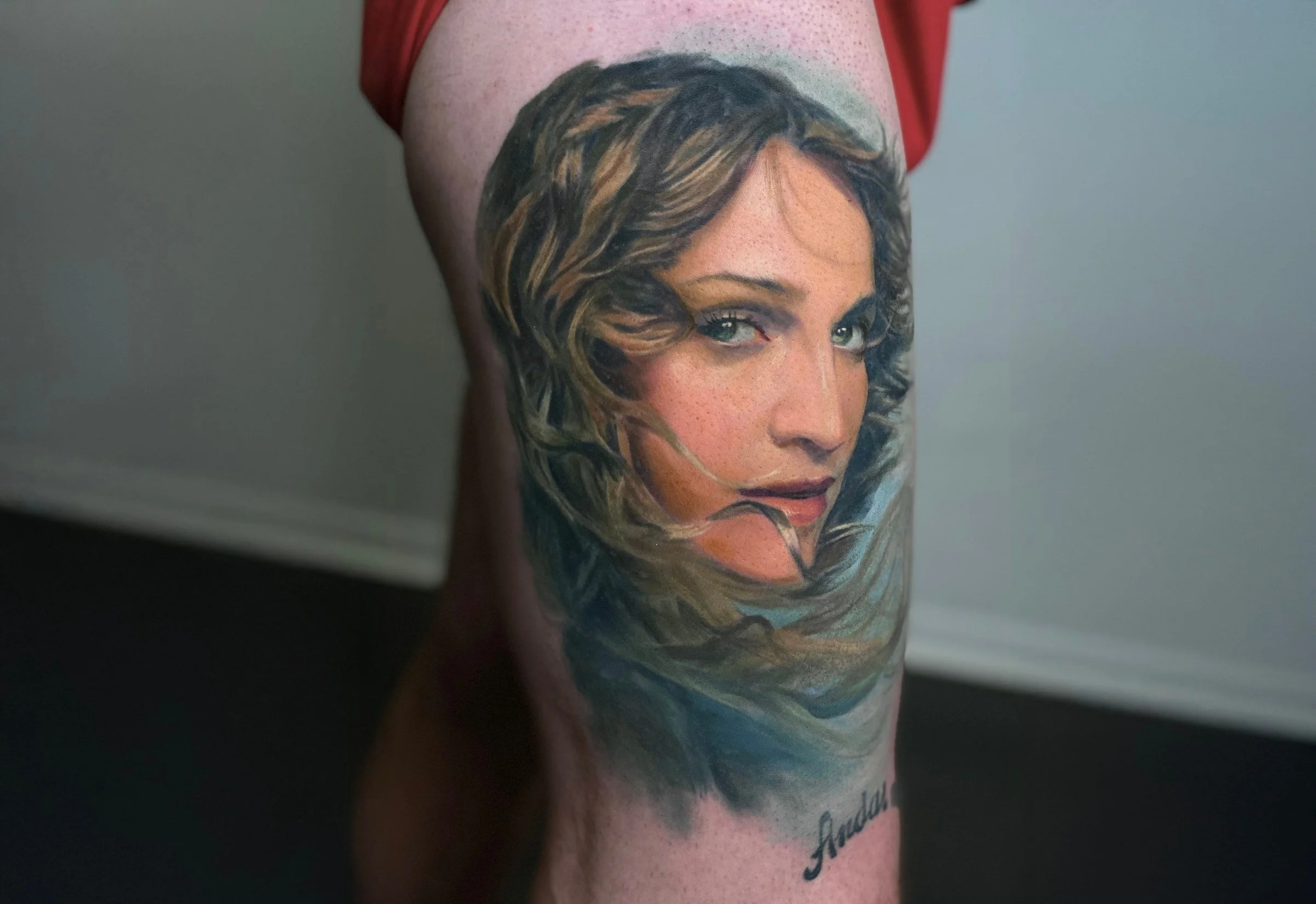 A color realism portrait of a woman with delicate shading and lifelike detail on the forearm.