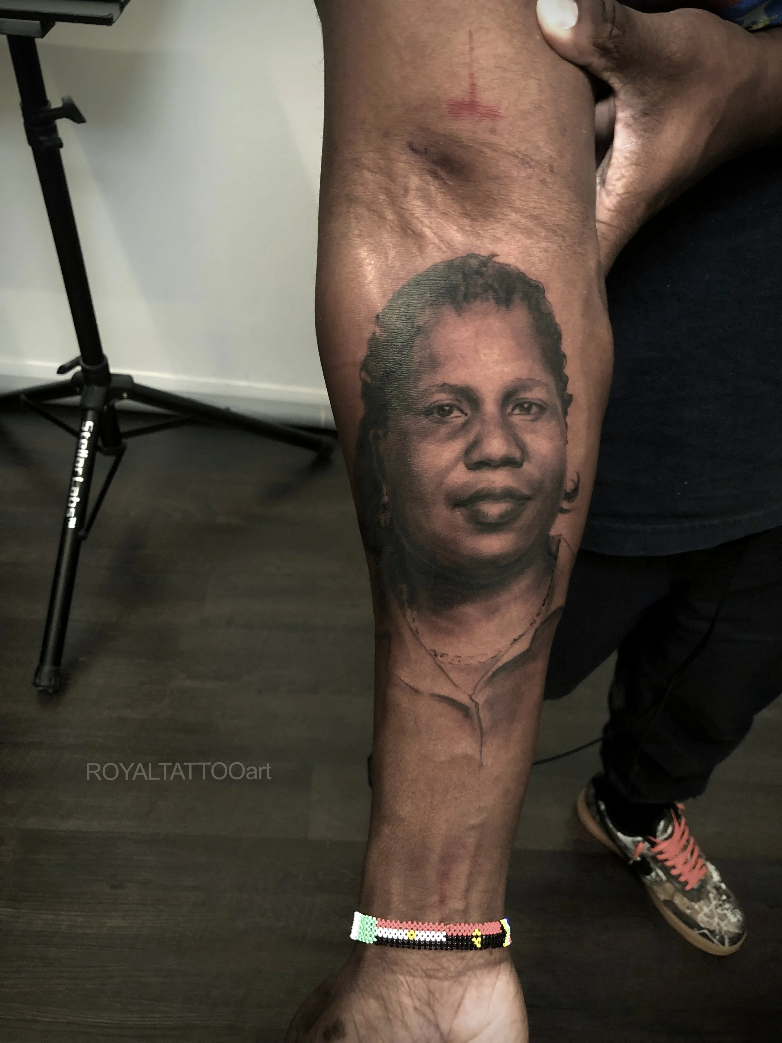 Child Portrait Black and Grey Realism Arm Tattoo – A heartfelt and photorealistic child portrait tattoo rendered in black and grey realism. Every soft facial feature is captured with exceptional detail, creating a timeless tribute by Royal Jafarov at