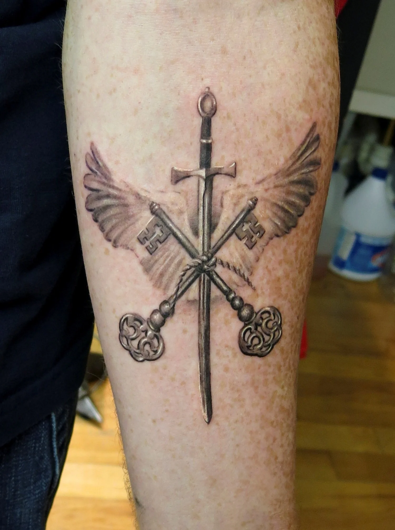 59-sword-keys-wings-forearm-tattoo-black-and-grey-realism-nyc.jpg