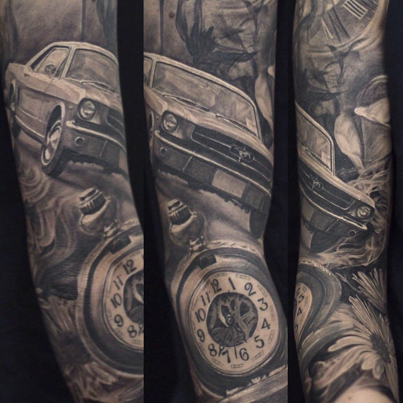 Close-up detail of a black and grey realism sleeve tattoo in NYC, showing a classic car with soft shading, smoke movement, and realistic texture by Royal Tattoo Art.