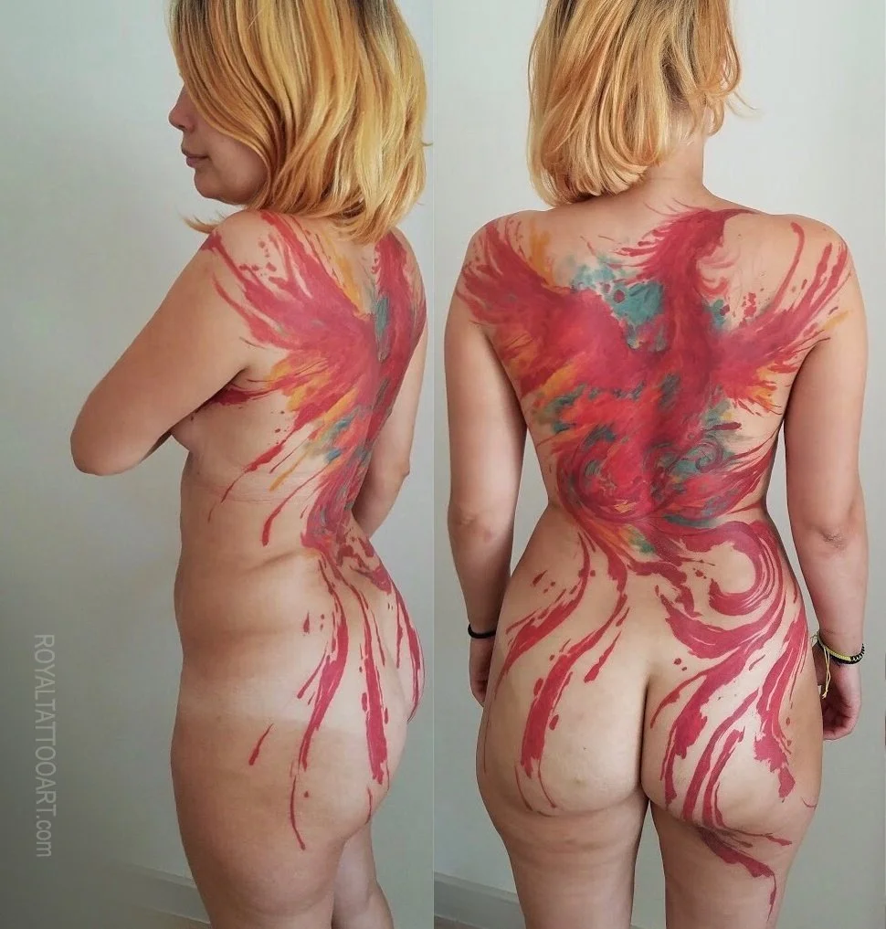 Abstract watercolor phoenix tattoo covering full back and body, featuring vibrant red brushstroke design by Royal Jafarov at Royal Tattoo Art
