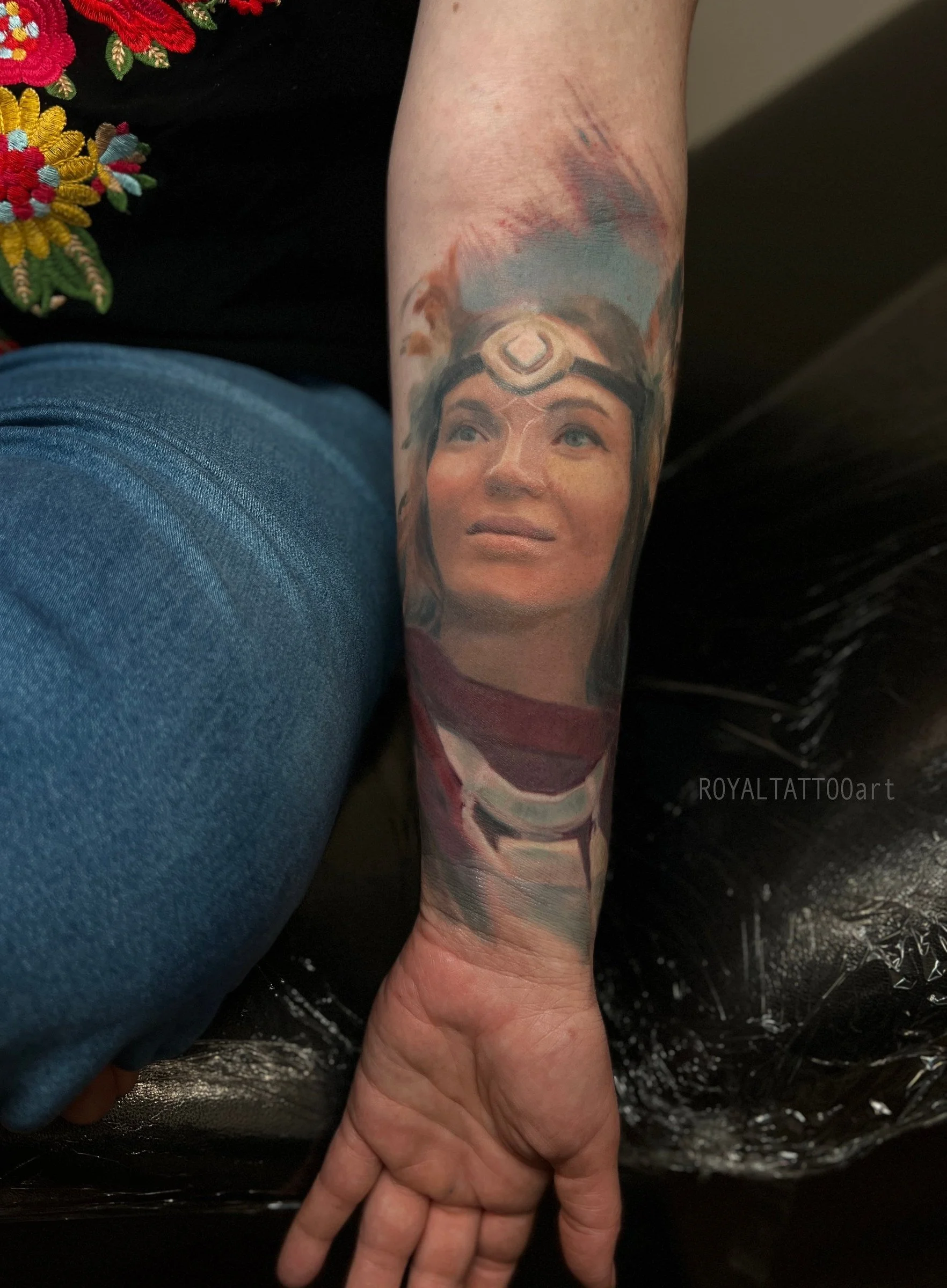 Color realism Lady Olena Uutai portrait tattoo on the forearm, created with soft expression, cultural detail, and painterly realism by Royal Jafarov in NYC.