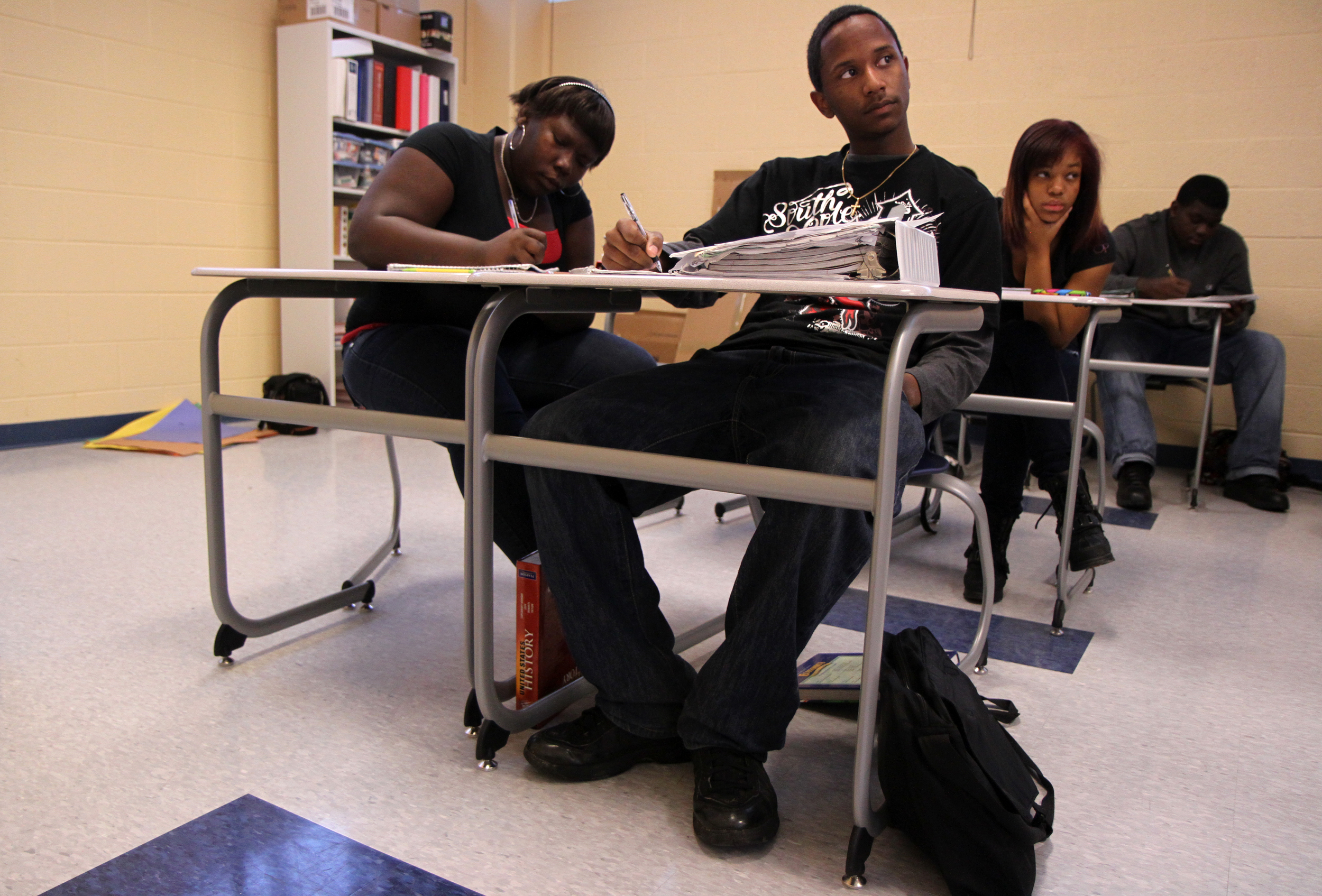  Tigner takes notes in his first class of the day, economics. He dreams of being an accountant someday. 