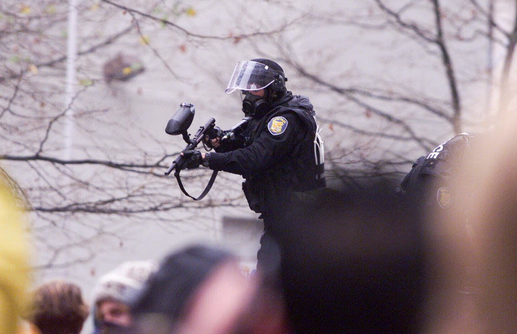 WTO riots, Seattle: policeman fires CS gas weapon