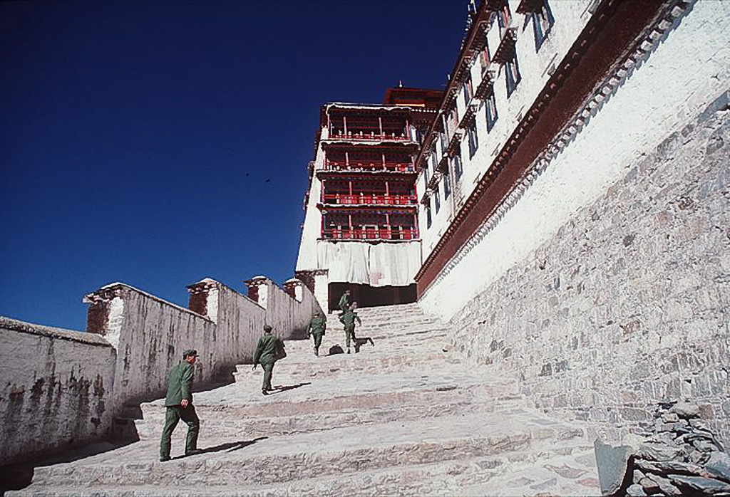 Chinese troops race up the steps of the Potola, Lhasa, Tibet