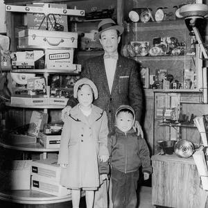 WITH FATHER AND SISTER IN A CHINATOWN, SAN FRANCISCO CAMERA STORE. 1957
