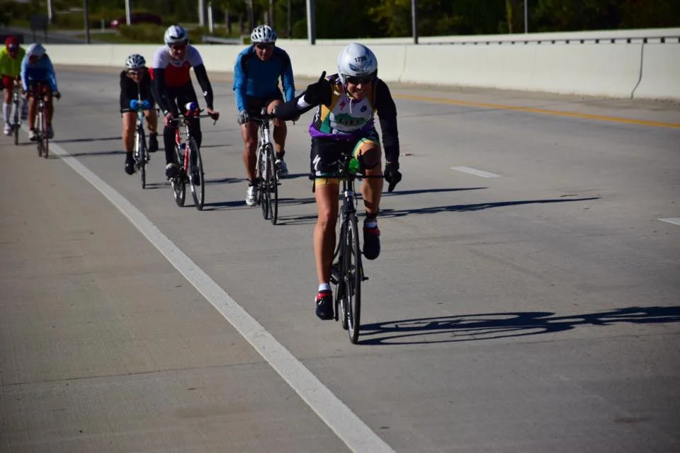 Tricia Adams, all thumbs up on the bike.