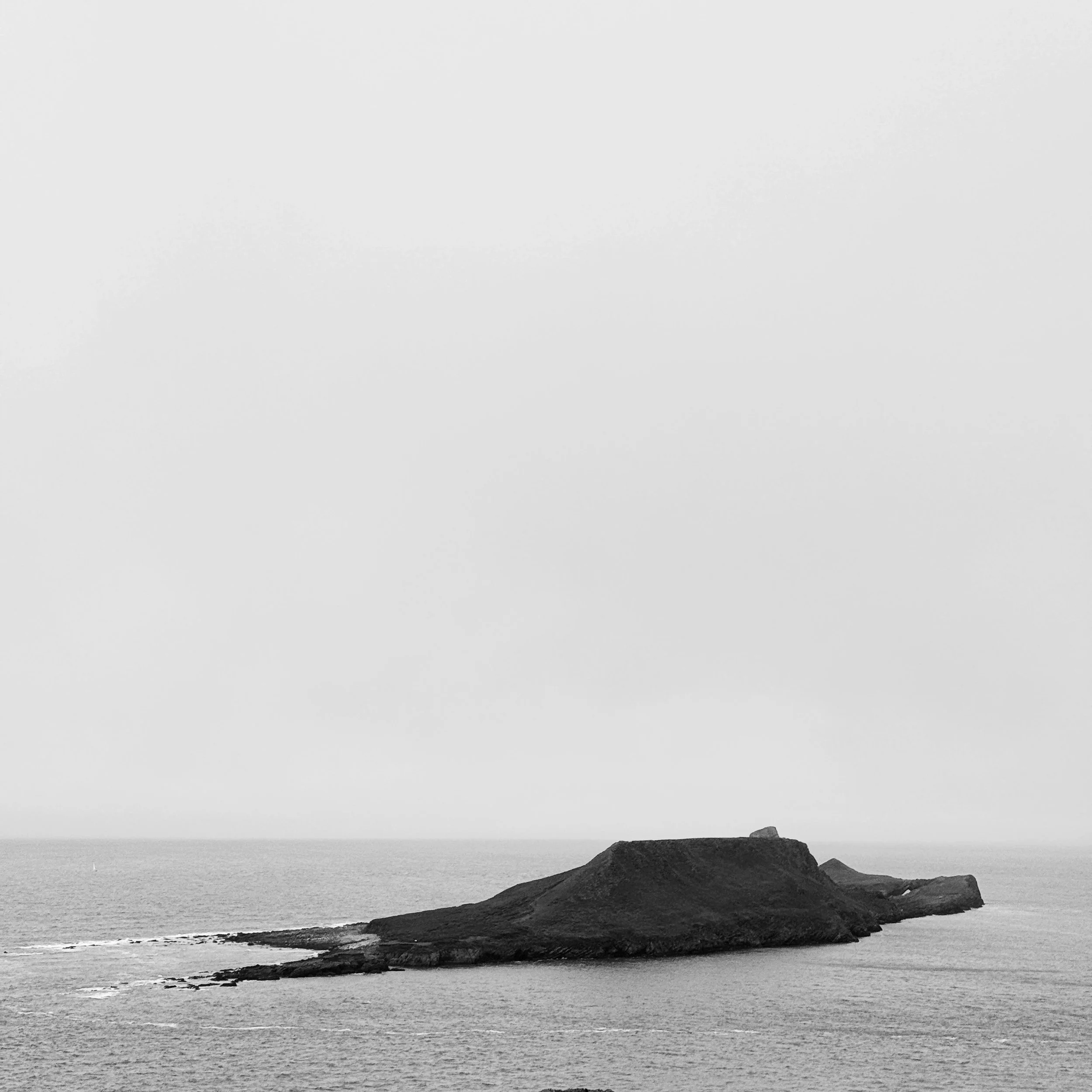 Many miles of coastline last week, more photographs taken than I expected, and for my weekly phone image I settled on this shot.
For me, the lovely shape of the land, the contrast between land water and sky, and the atmosphere from the mist (it was