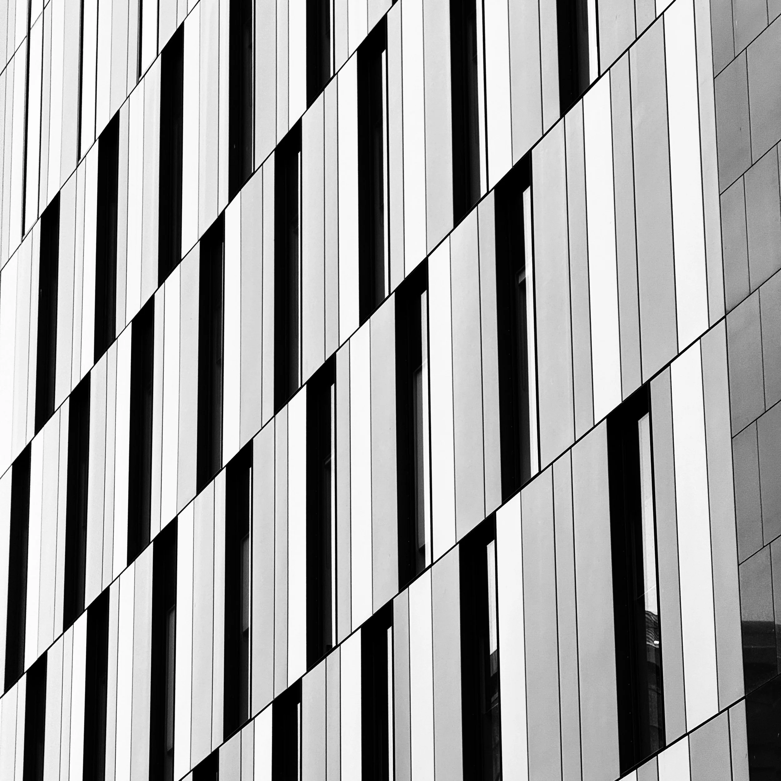 A stinking cold at the end of last week and the weekend really restricted opportunities but I was taking a different route home and the light on the panels of this building really caught my eye.