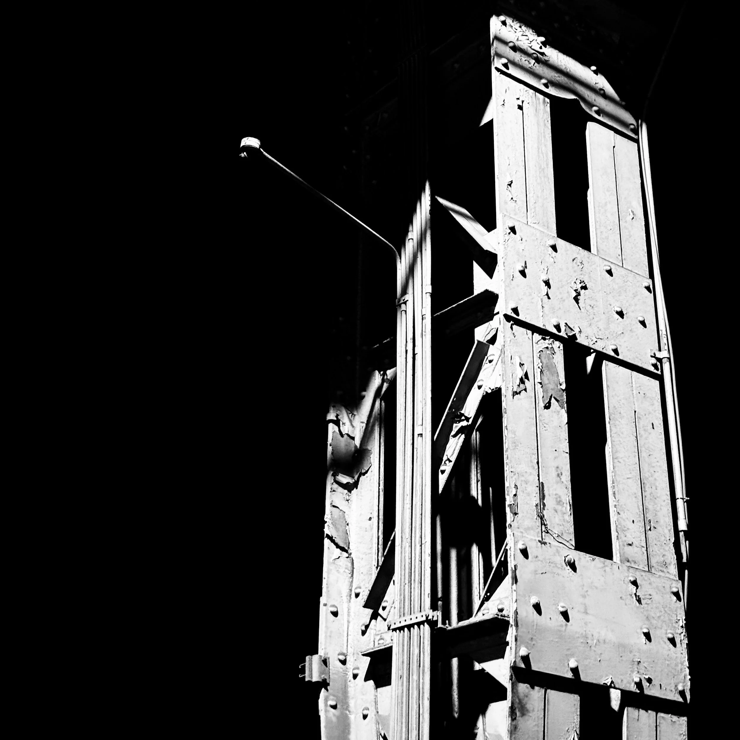 Industrial Tracking

This week I found myself at an exhibition being held in what felt like an abandoned industrial complex.

I spent time exploring the nooks and crannies of the buildings but was drawn to the steel structures and the shadows created