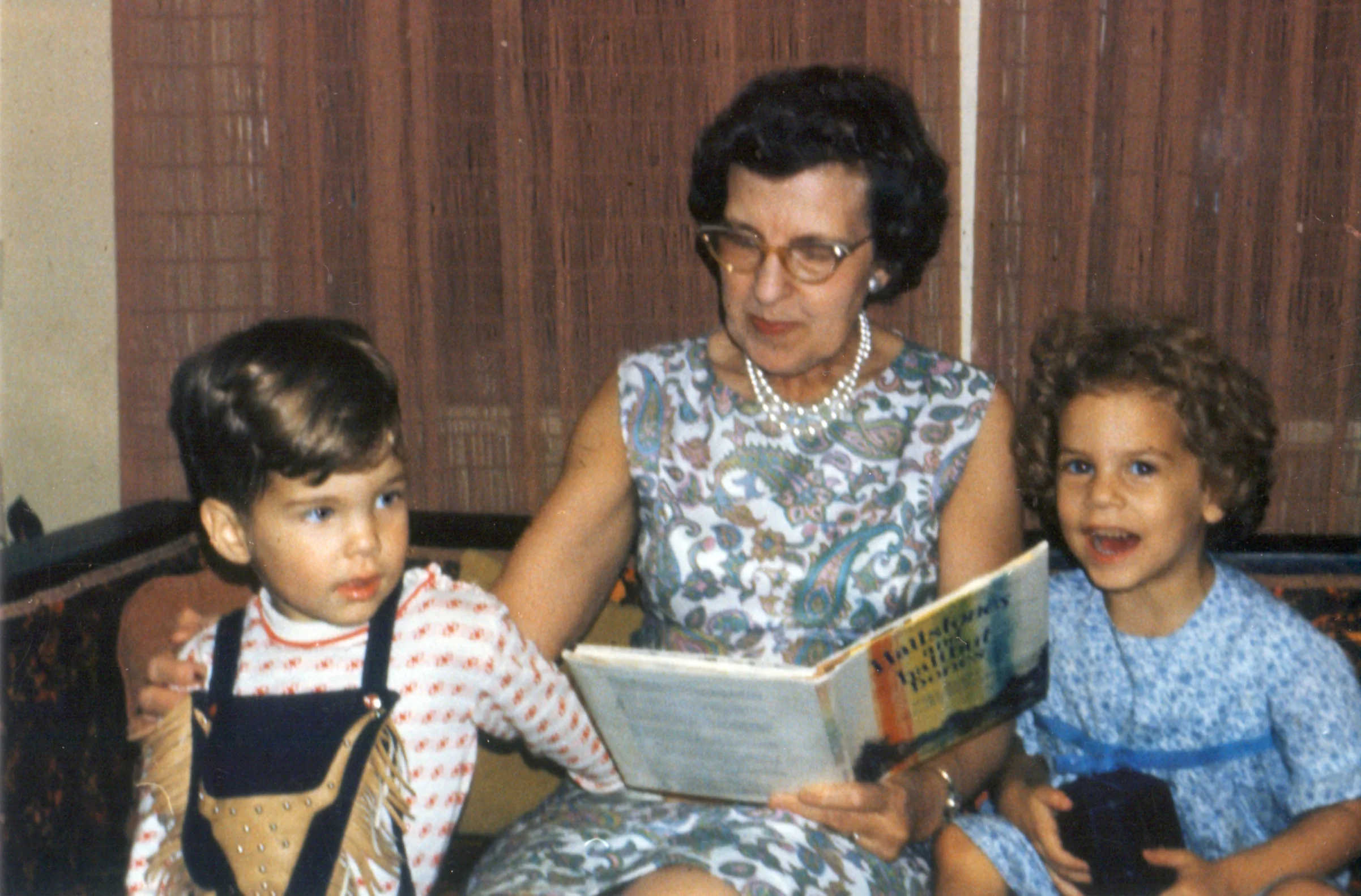 My grandmother reads to my brother and me. No wonder I love books so much. (And I appear to be holding a camera...hhmmmm....)