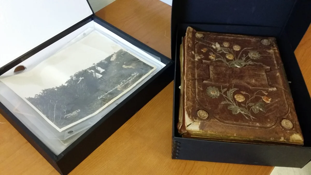 Two archival storage boxes contain unidentified ancestral photos.