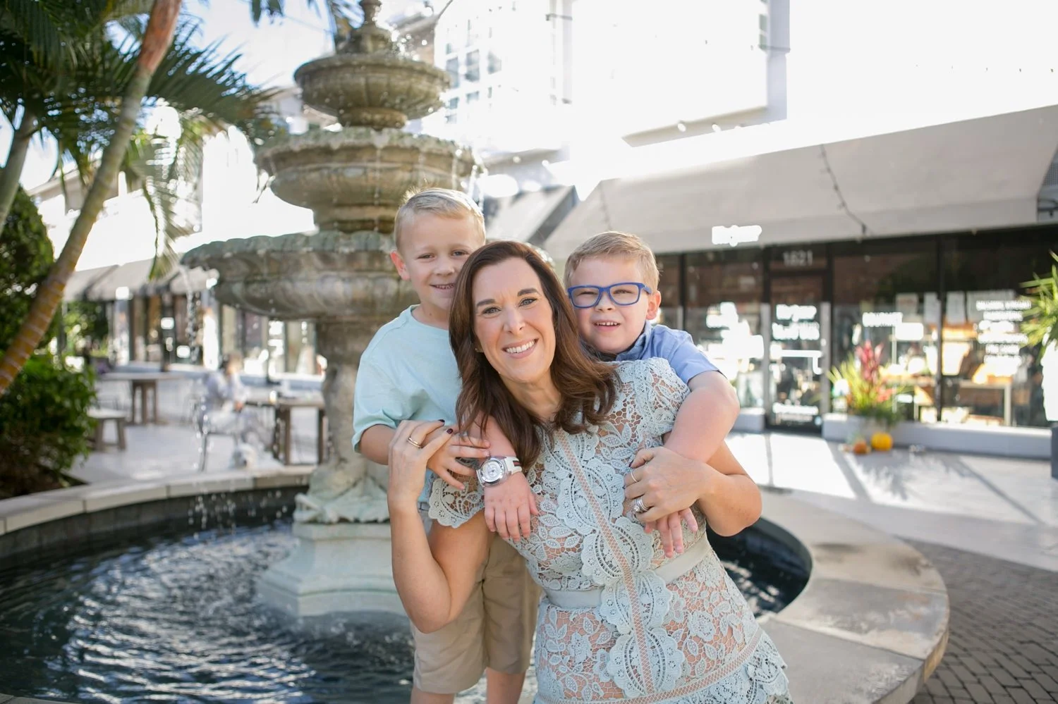 Mom with each of her twin boys during a candid family portrait session at Hyde Park Village in Tampa