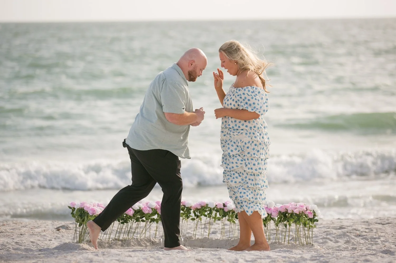 Bride-to-be reacting in surprise as her partner begins to propose at Upham Beach, St. Pete Beach