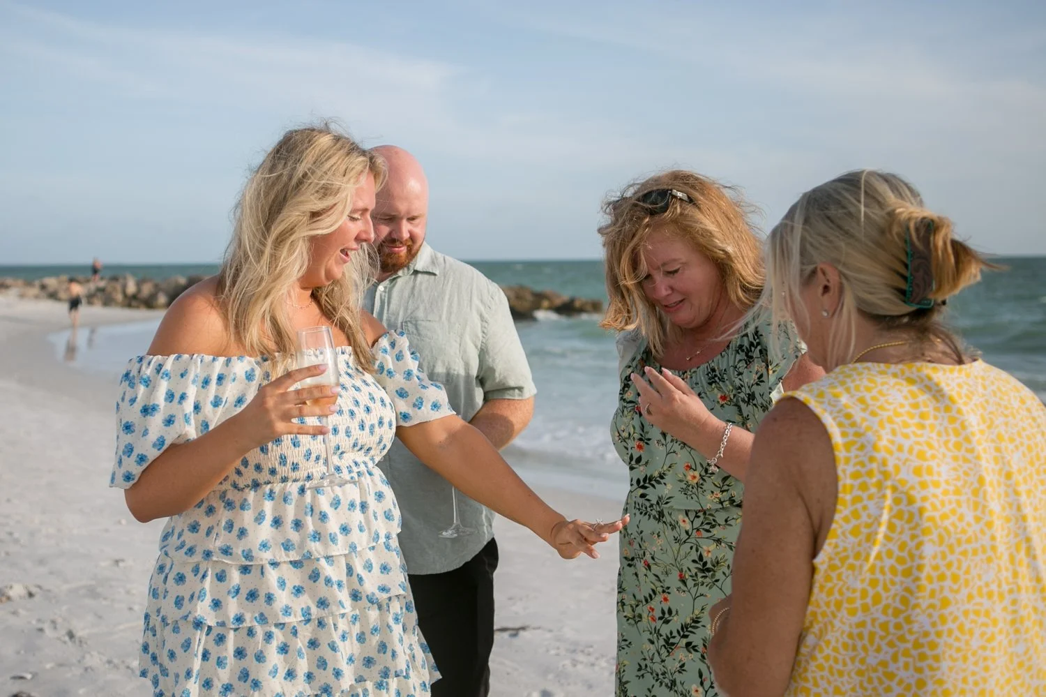 Bride-to-be showing her engagement ring to family after a surprise proposal in St. Pete Beach
