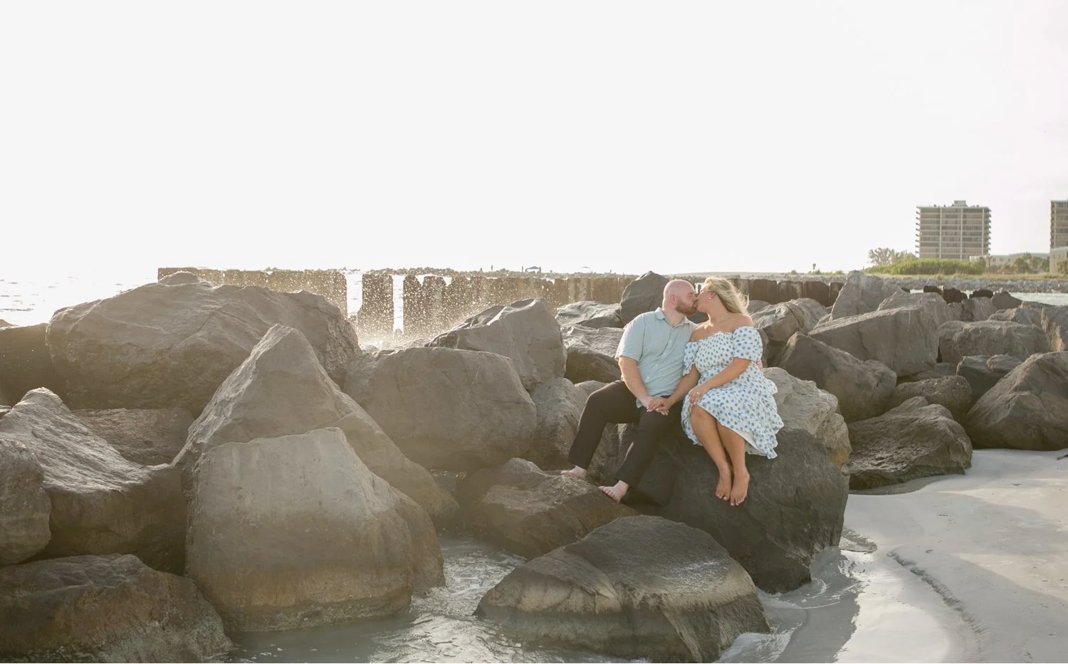 Couple kissing on the rock breakwall at Upham Beach, St. Pete Beach