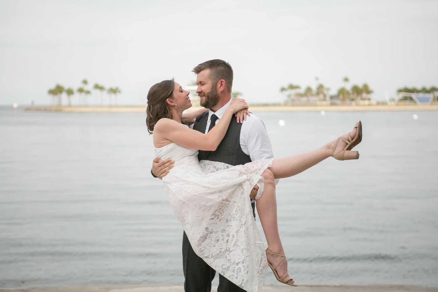Groom-to-be lifting his fiancée by the St. Pete waterfront during their engagement session