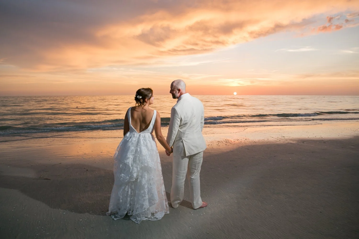 sunset photos on the beach of newly married couple at the Don Cesar on St. Pete Beach