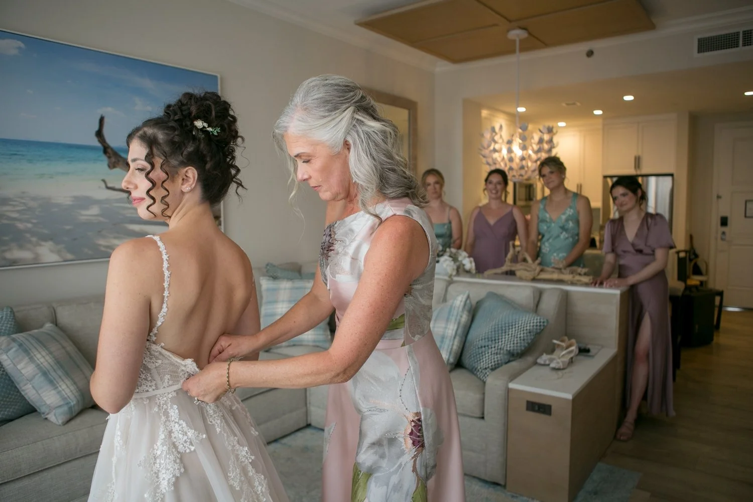 Mother of the bride helping with wedding dress buttons at Sand Pearl Resort wedding — Carrie Wildes Photography