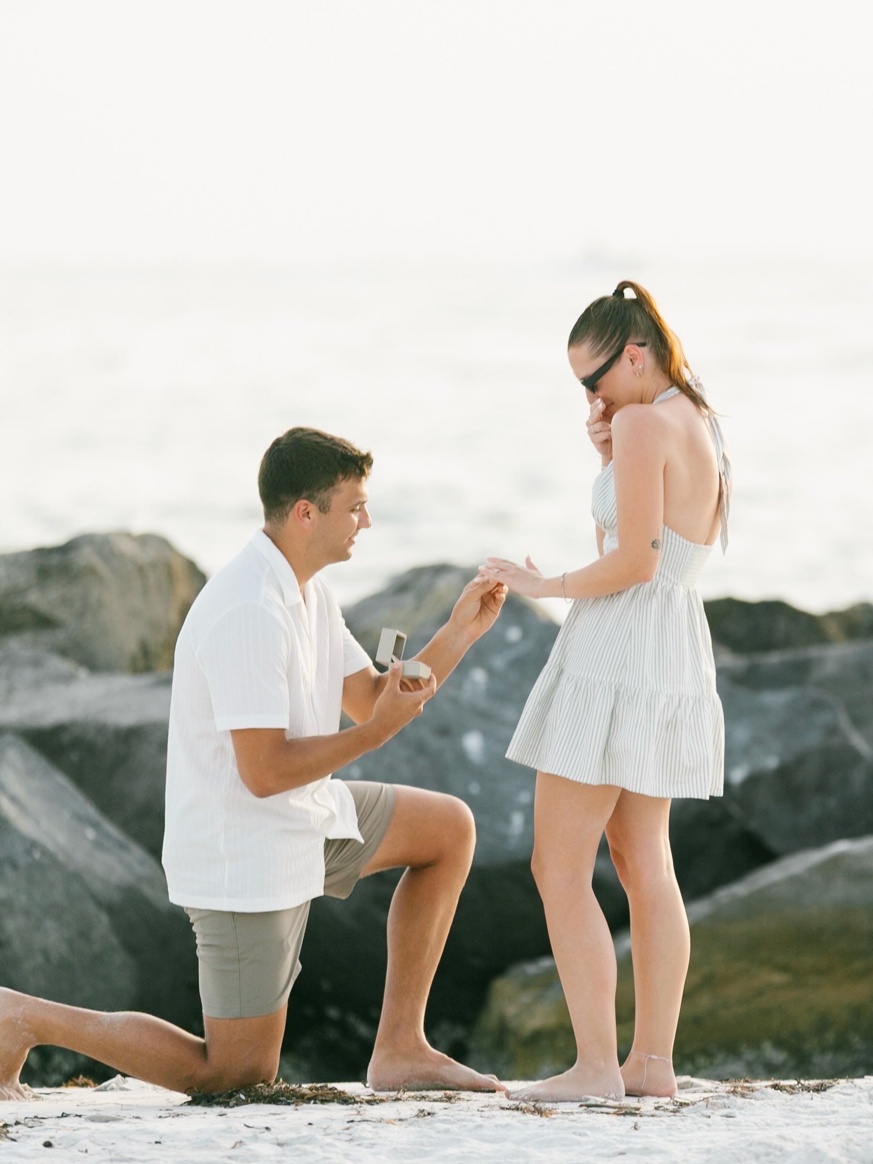 Today&rsquo;s the day! 🤍

Before Kori and Nick say &ldquo;I do&rdquo; this afternoon, I had to look back at where this part of their journey began: a quiet stretch of Gulf Coast sand, the rocks behind them, and Nick down on one knee while Kori stare