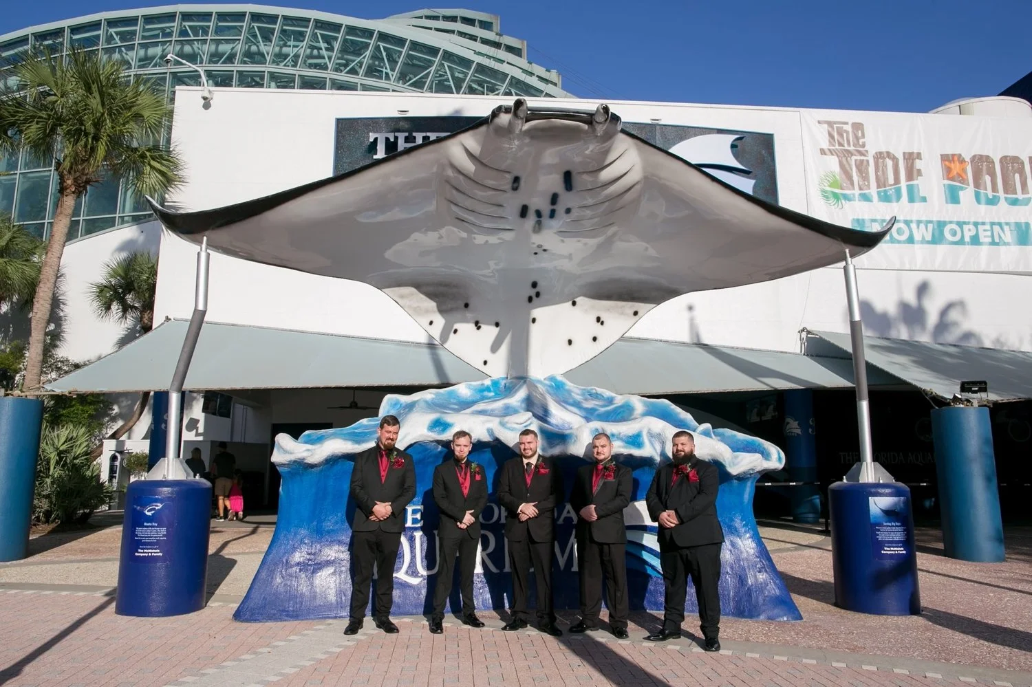 Groom and groomsmen under the giant manta ray sculpture at The Florida Aquarium entrance