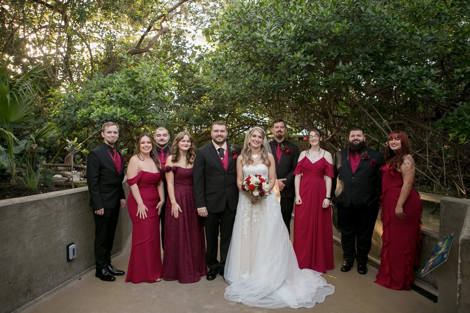 Wedding party in burgundy and black among the mangroves at The Florida Aquarium