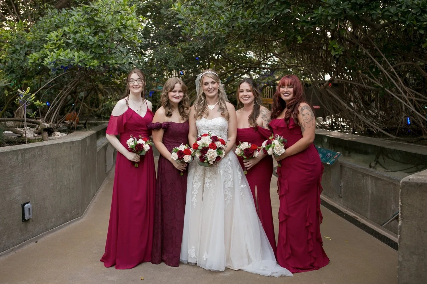 Bride with her bridesmaids in burgundy gowns
