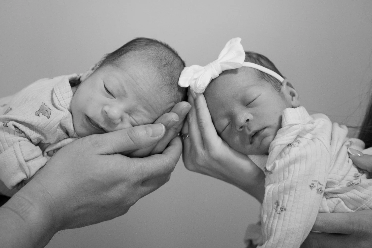 Black and white photo of newborn boy girl twins sleeping Tampa