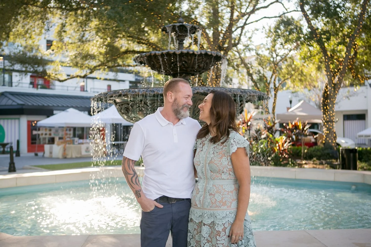 Couple posing together in front of the ornate fountain at Hyde Park Village in Tampa