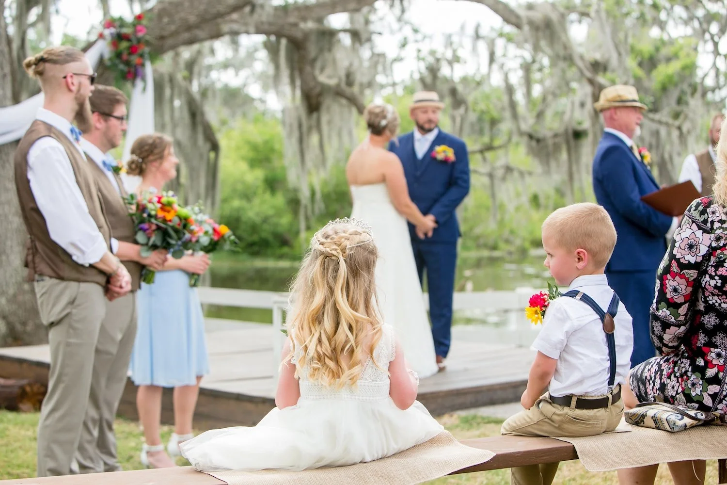 Outdoor ceremony in tampa bay from the ring bearer and flower girl perspective