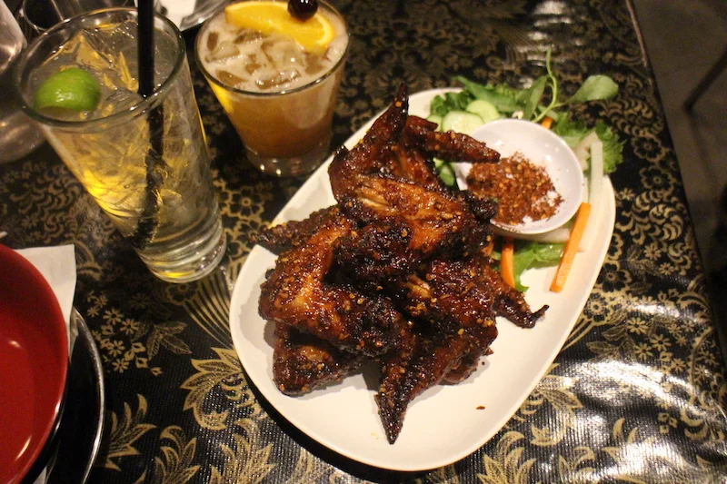 Must Order - Ike’s Vietnamese Fish Sauce Wings | Half dozen fresh whole natural chicken wings marinated in fish sauce and sugar, deep fried, tossed in caramelised Vietnamese fish sauce and garlic and served with Cu Cai (pickled vegetables.) 