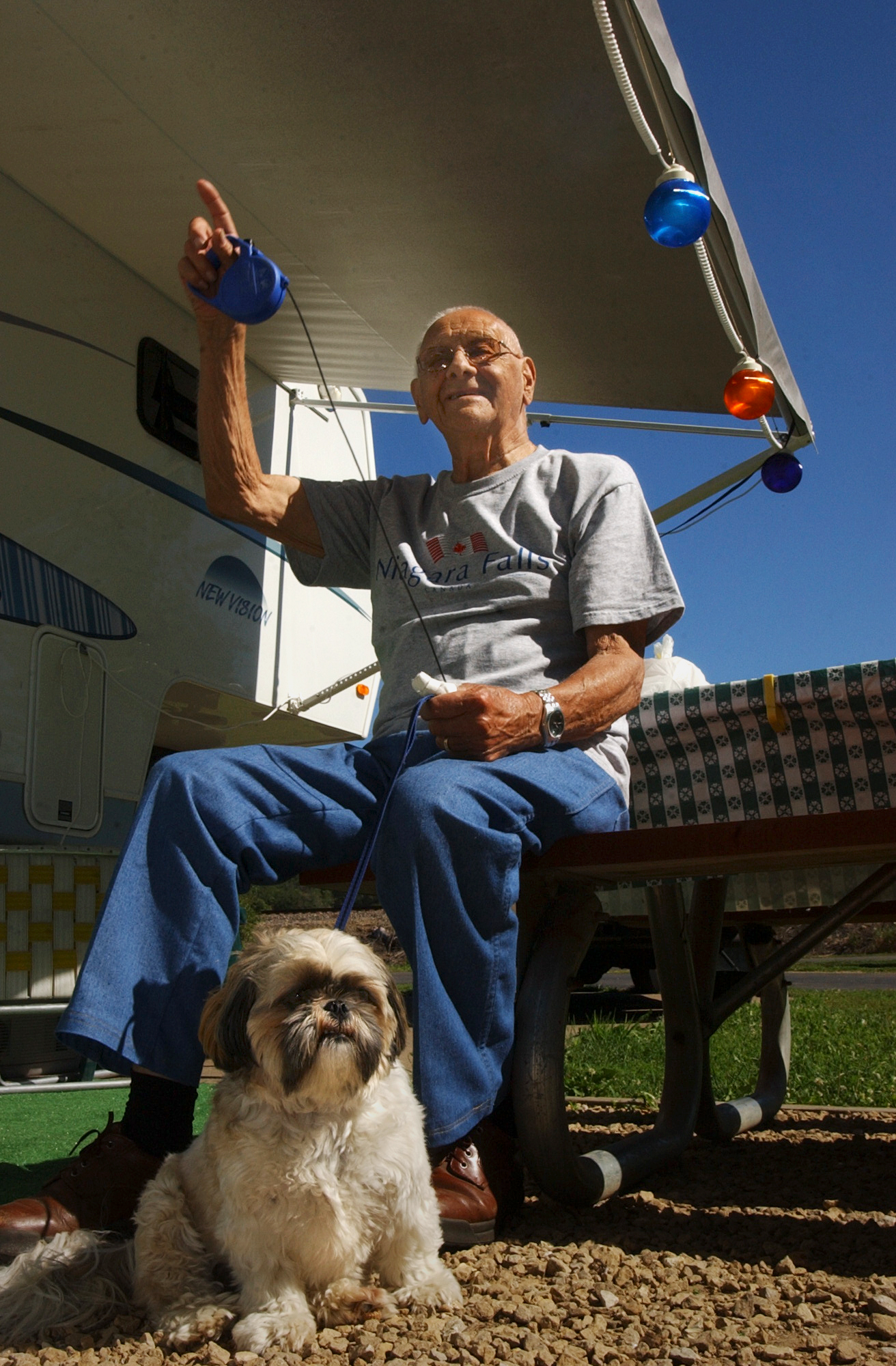  Jack Prochaska waves to his neighbors while and his Shitzu, Tootsie, are spending Labor Day weekend at the Grant River Use Area. "I don't know how often we'll be able to make it anymore, with the cost of gasoline," commented Prochaska, who comes to 