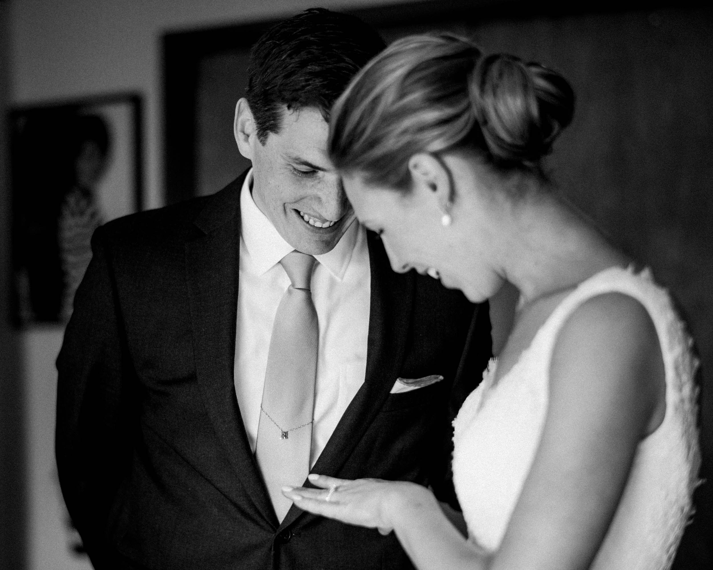 Bride and groom admire wedding ring