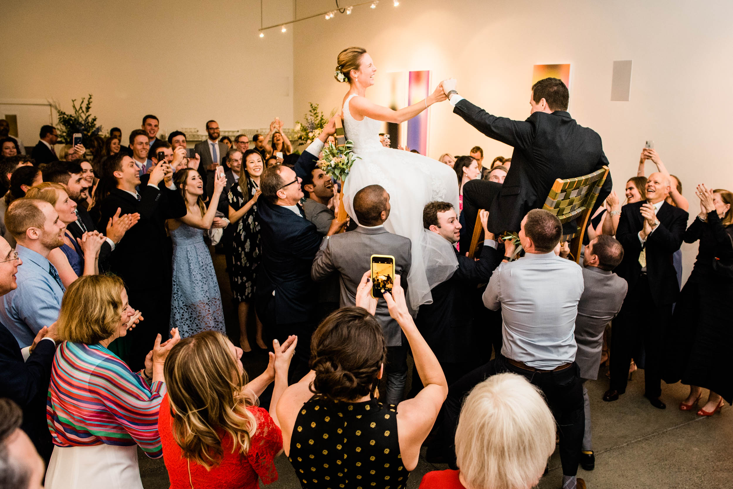 Bride and groom during horah during wedding at Foreign Cinema's Modernism West gallery