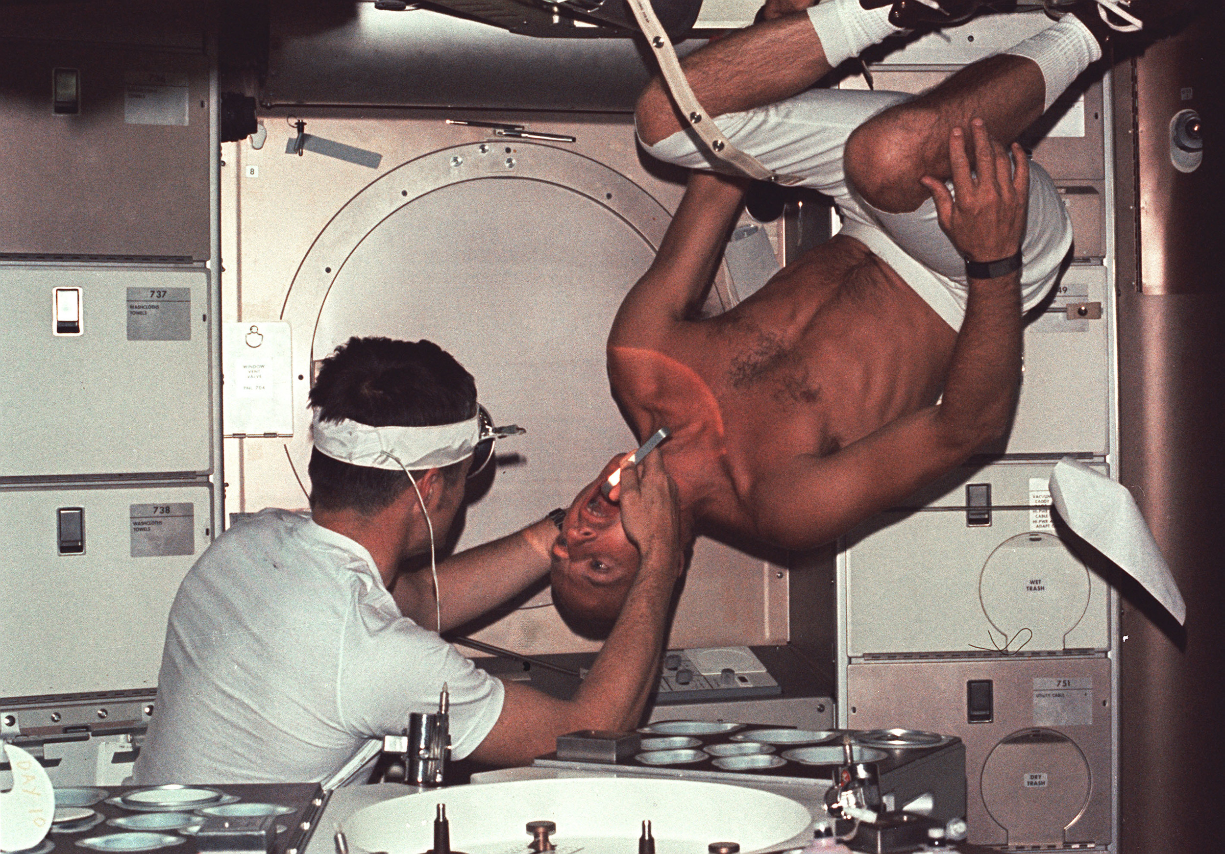 Dr Joe Kerwin examines fellow astronaut Pete Conrad on Skylab in 1973.