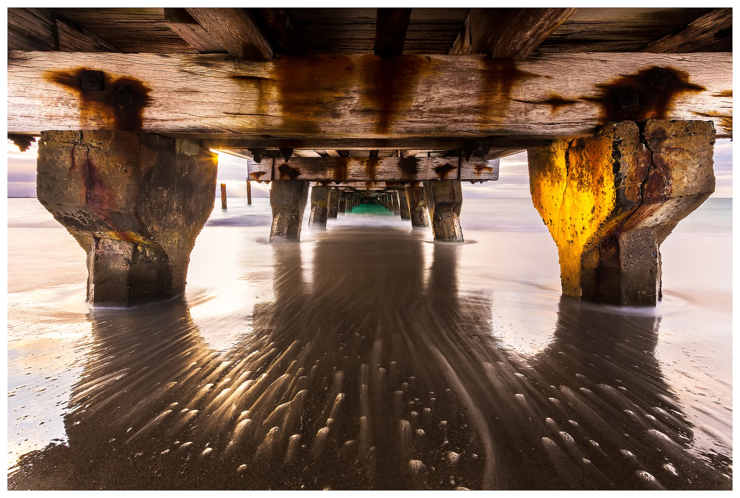 Sunset under the jetty
