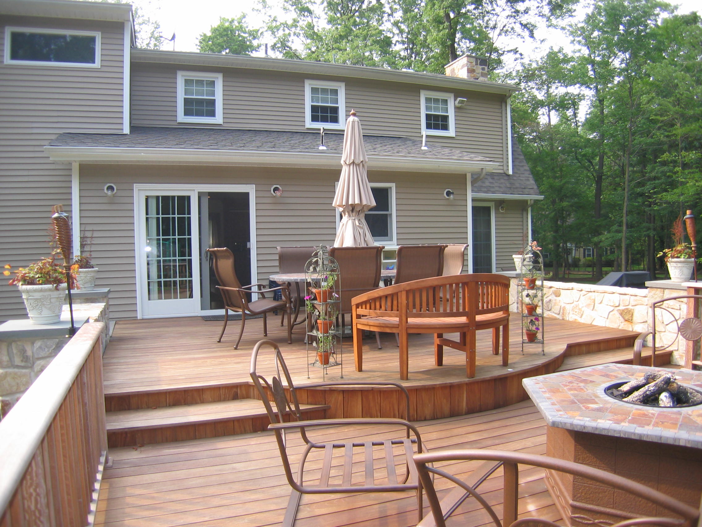  A two tiered deck with integral fire pit makes the kitchen addition beyond the true central focus of this Warren home. 